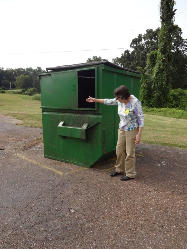 Pat Barnwell showing how a dumpster door left open can lead to infestation